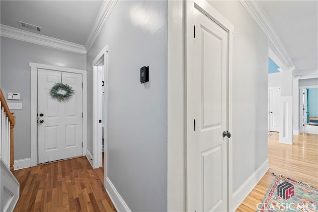 hall featuring ornamental molding and hardwood / wood-style flooring