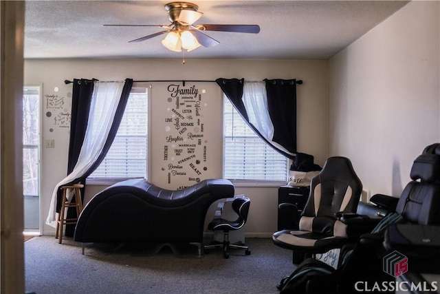 interior space with ceiling fan and a textured ceiling