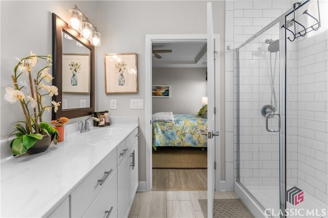 bathroom featuring walk in shower and vanity