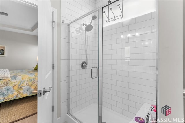 bathroom featuring a shower with door