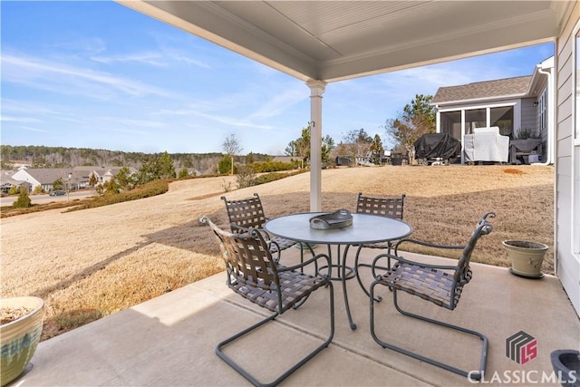 view of patio / terrace featuring a sunroom