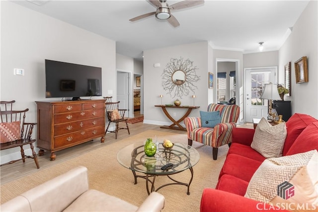 living room with ceiling fan and light hardwood / wood-style flooring