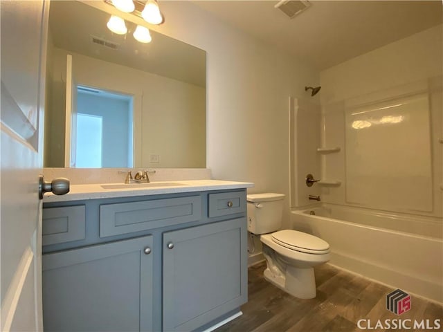 full bathroom with toilet, wood-type flooring, vanity, and shower / bathing tub combination