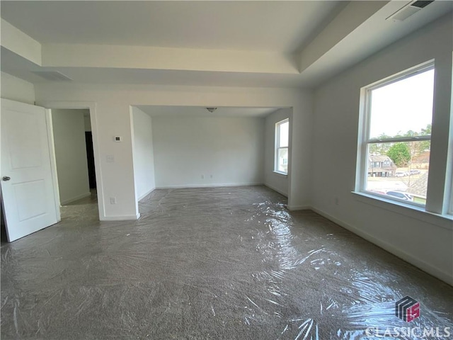 spare room featuring a raised ceiling