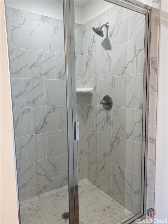 bathroom with a shower with door