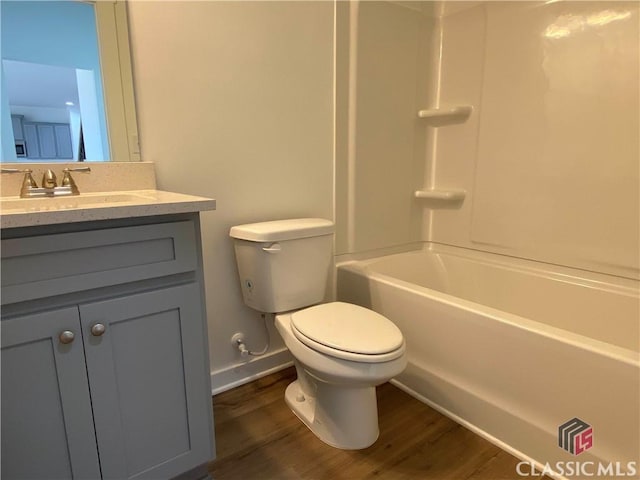 full bathroom featuring toilet, vanity, washtub / shower combination, and hardwood / wood-style floors