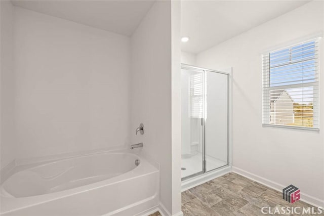 bathroom featuring separate shower and tub