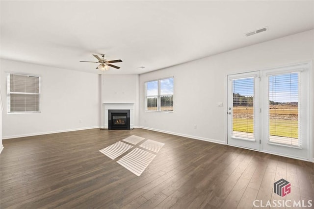 unfurnished living room with ceiling fan and dark hardwood / wood-style floors