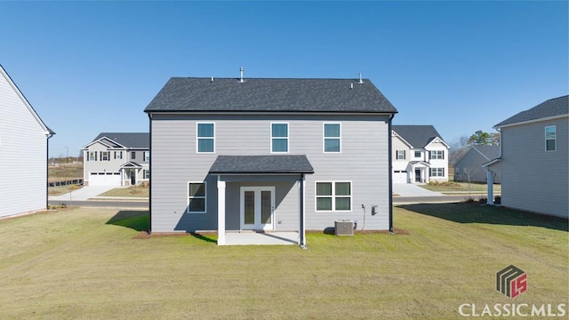 back of property featuring cooling unit, a patio area, and a yard