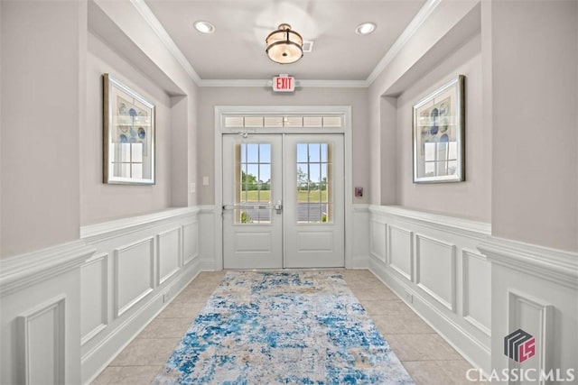 doorway to outside with light tile patterned floors, ornamental molding, and french doors