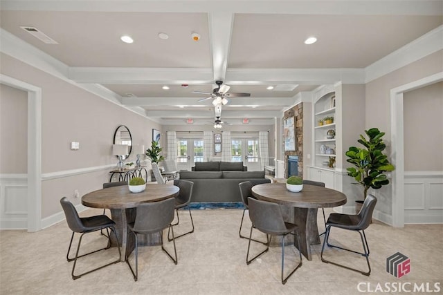 dining area featuring french doors, beamed ceiling, built in features, ornamental molding, and ceiling fan