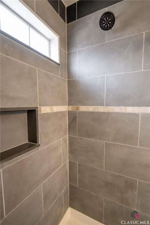 bathroom with a tile shower