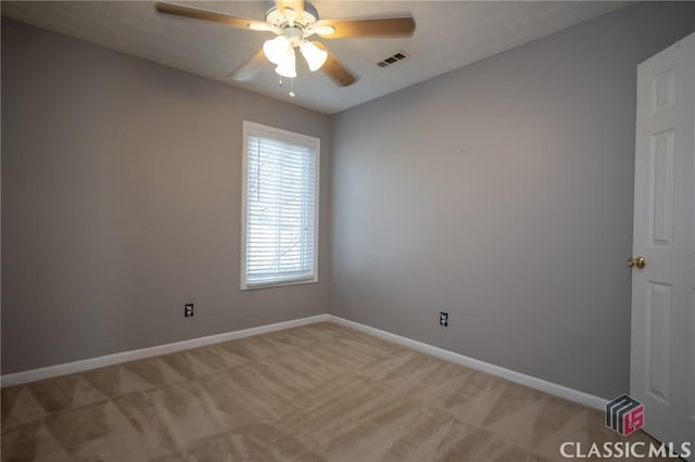 carpeted spare room with ceiling fan