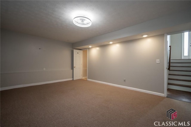 basement featuring carpet floors and a textured ceiling