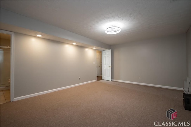 basement featuring a textured ceiling and carpet