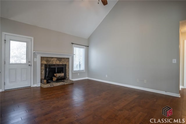 unfurnished living room with high vaulted ceiling, dark hardwood / wood-style flooring, ceiling fan, and a fireplace