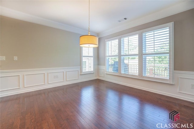 empty room featuring dark hardwood / wood-style flooring and ornamental molding