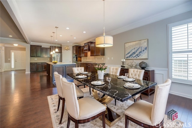 dining area featuring dark wood-type flooring and crown molding