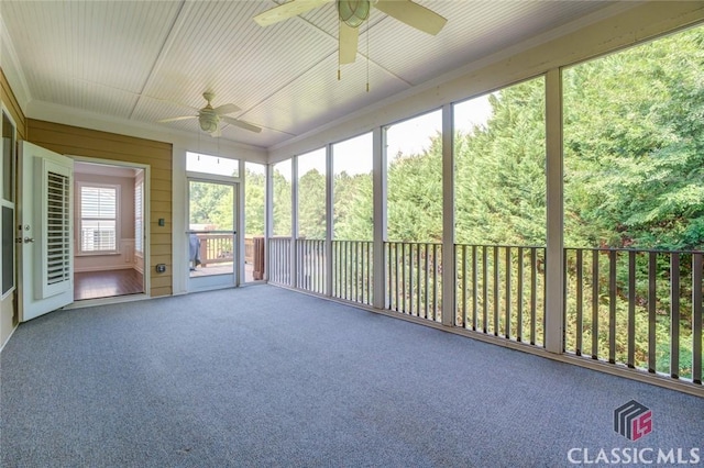 unfurnished sunroom with ceiling fan