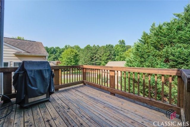 wooden terrace featuring area for grilling