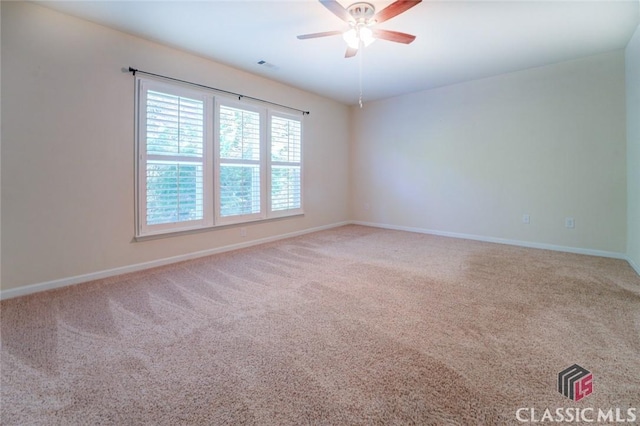 unfurnished room featuring ceiling fan and carpet flooring