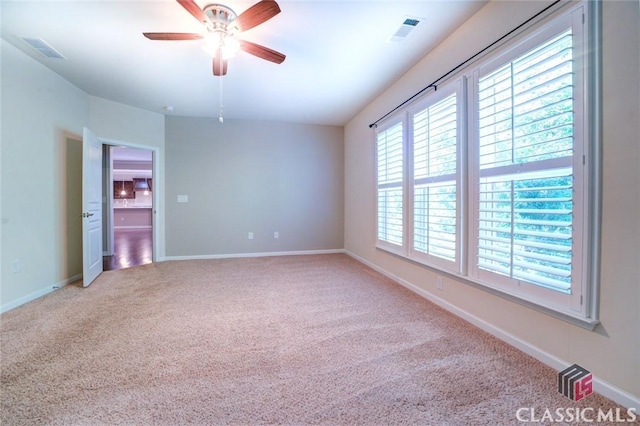 empty room with ceiling fan and light colored carpet