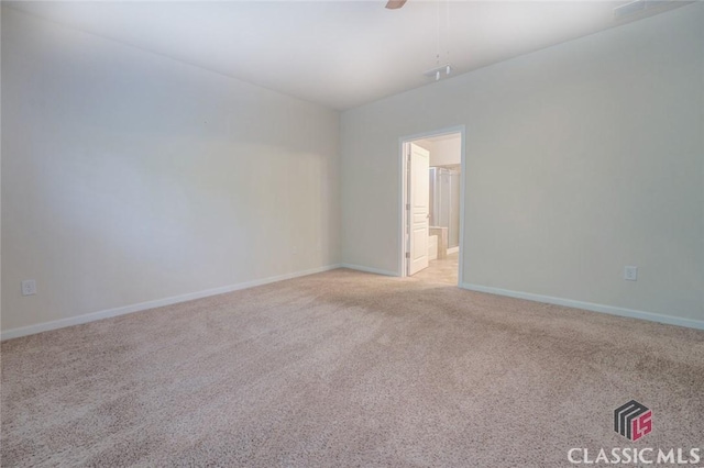 carpeted spare room with ceiling fan