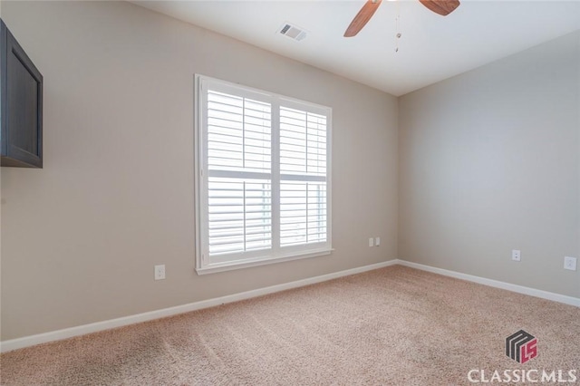 spare room with ceiling fan, plenty of natural light, and carpet floors