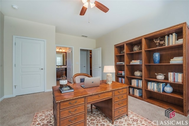 office featuring ceiling fan and light colored carpet