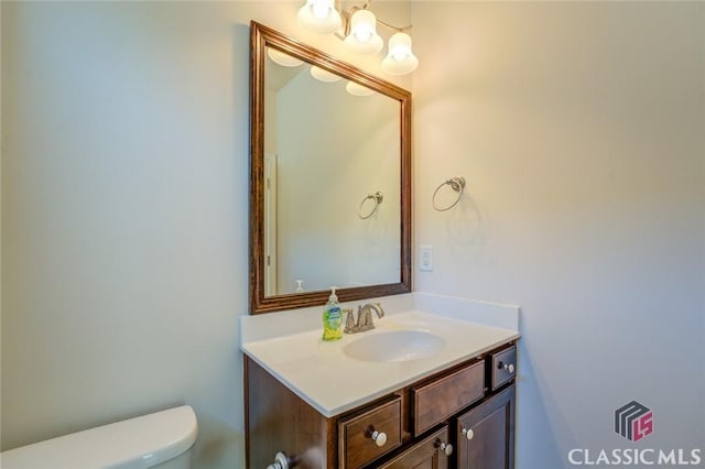 bathroom with toilet and vanity