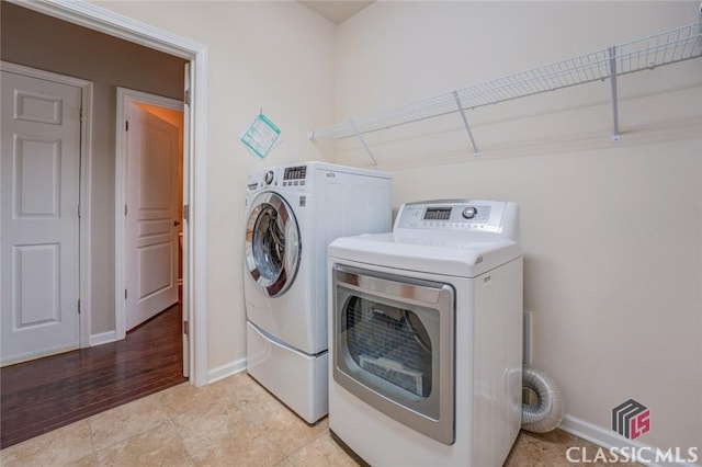 washroom with washing machine and clothes dryer