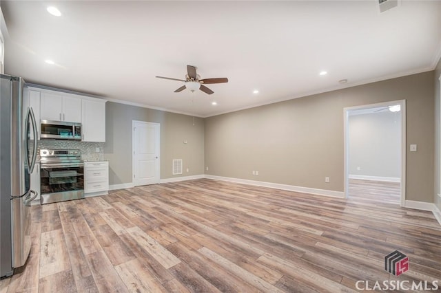 kitchen with ceiling fan, backsplash, white cabinetry, light hardwood / wood-style flooring, and stainless steel appliances