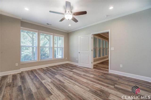 empty room featuring ceiling fan, hardwood / wood-style floors, and crown molding