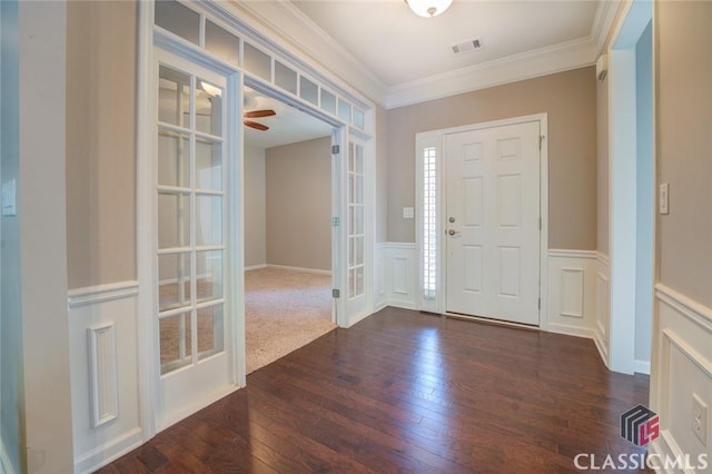 foyer entrance featuring french doors, dark wood-type flooring, and ornamental molding