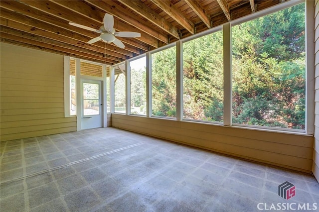 unfurnished sunroom with ceiling fan