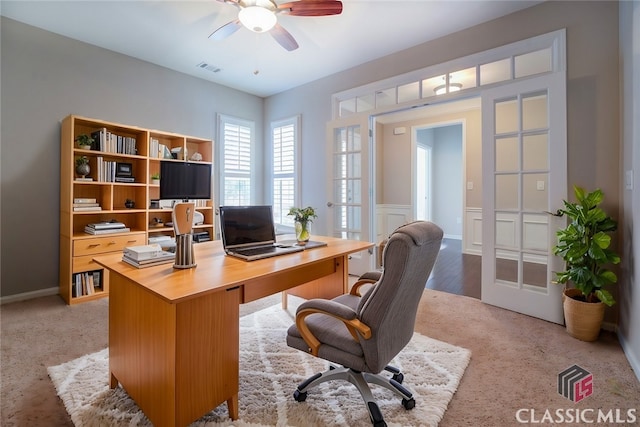 carpeted home office featuring ceiling fan and french doors