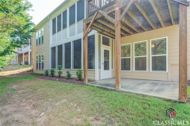 view of home's exterior with a patio area and a yard