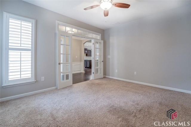 unfurnished room featuring ceiling fan, french doors, and carpet