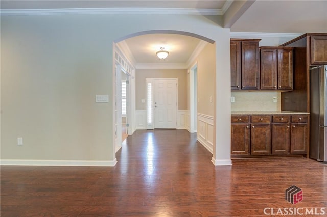 foyer with dark hardwood / wood-style flooring and crown molding