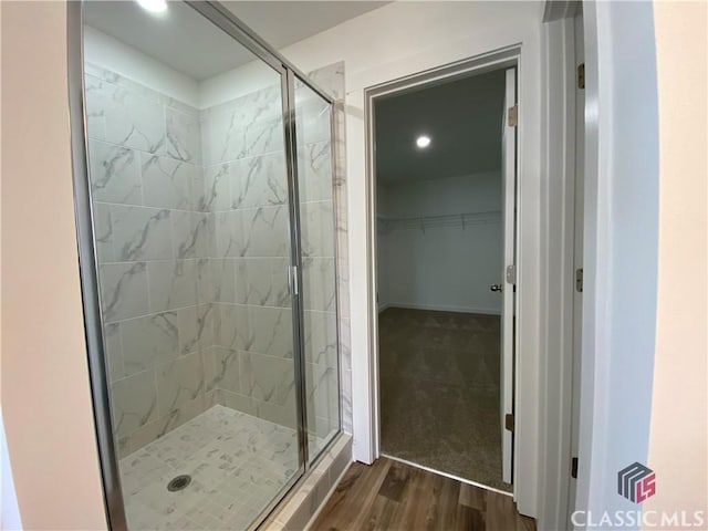 bathroom with hardwood / wood-style floors and walk in shower