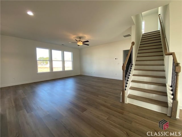 unfurnished living room with ceiling fan and dark hardwood / wood-style flooring