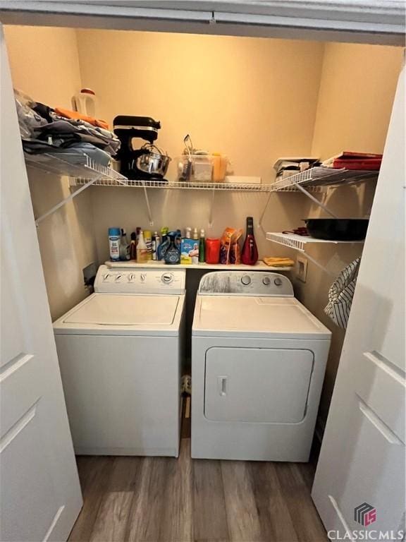 laundry area featuring dark hardwood / wood-style floors and separate washer and dryer