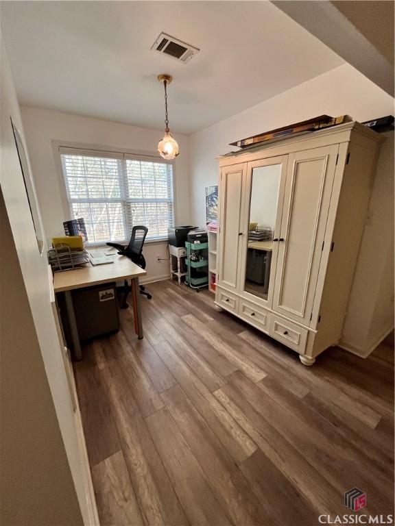 home office with wood-type flooring