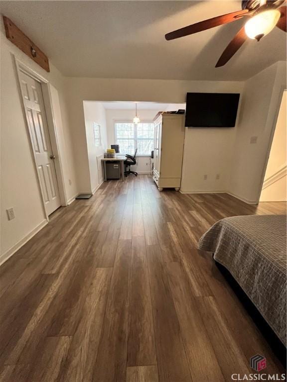 unfurnished bedroom featuring ceiling fan and dark hardwood / wood-style floors