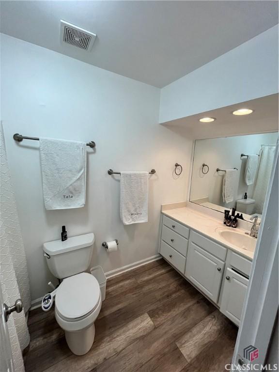 bathroom featuring hardwood / wood-style floors, toilet, and vanity