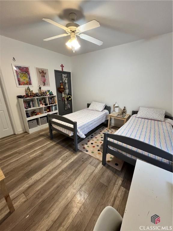 bedroom with ceiling fan and hardwood / wood-style flooring