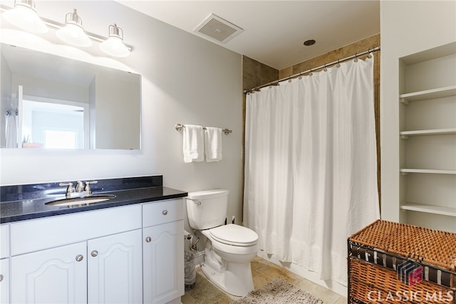 bathroom featuring toilet, tile patterned flooring, and vanity