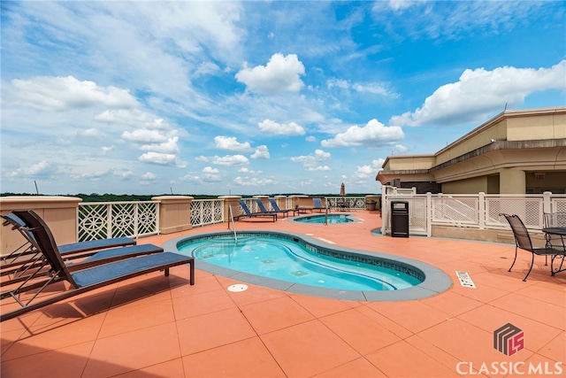 view of swimming pool with a patio