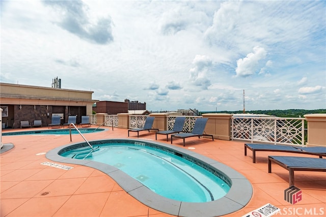 view of pool with a community hot tub and a patio