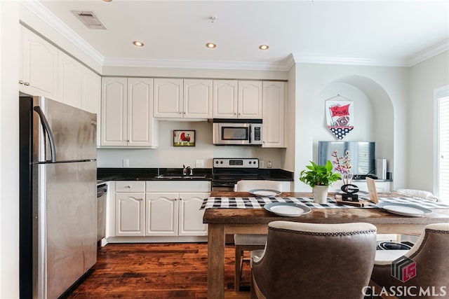 kitchen with white cabinets, dark wood-type flooring, sink, and stainless steel appliances